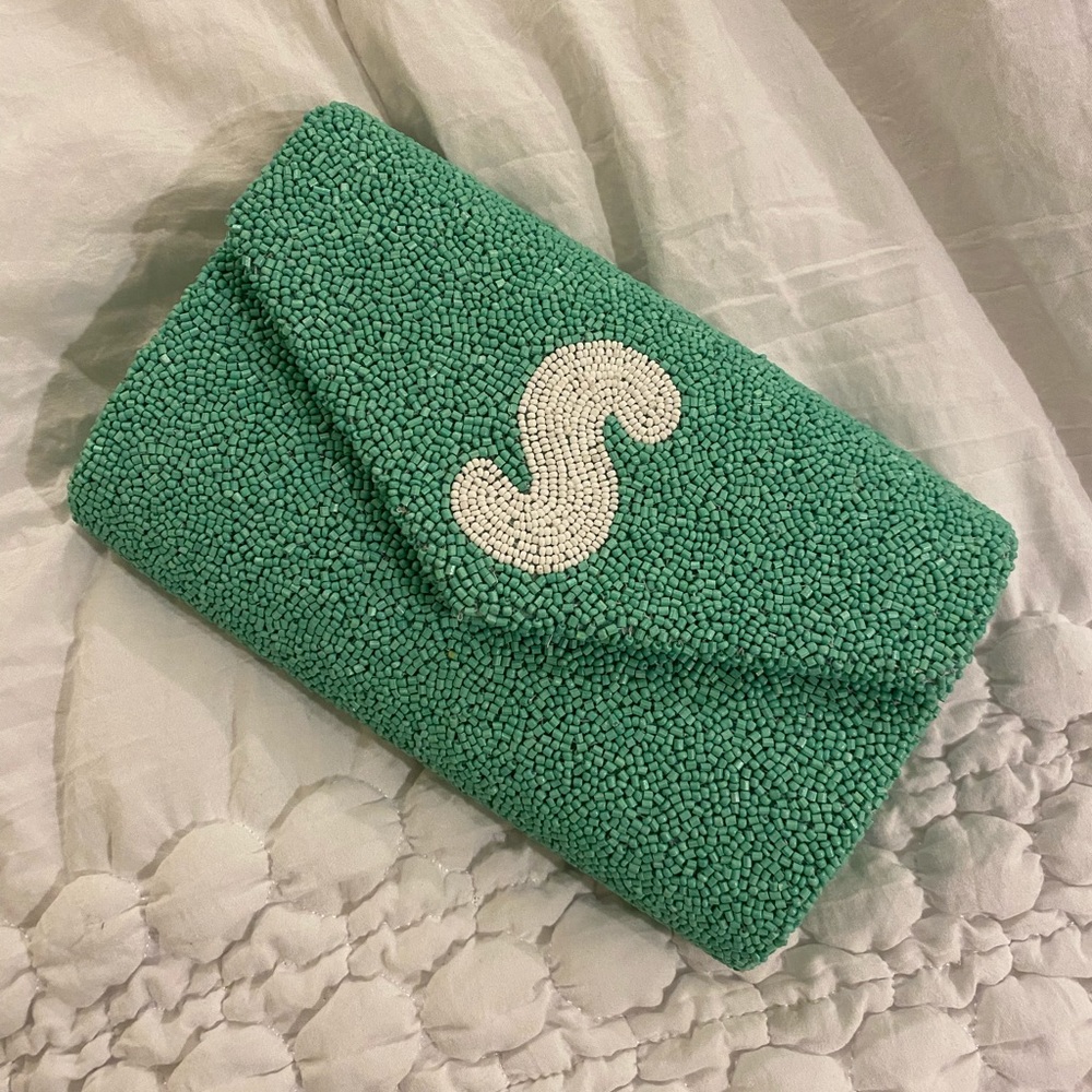 Beaded clutch with monogrammed “S” on front. Color is a mint green.